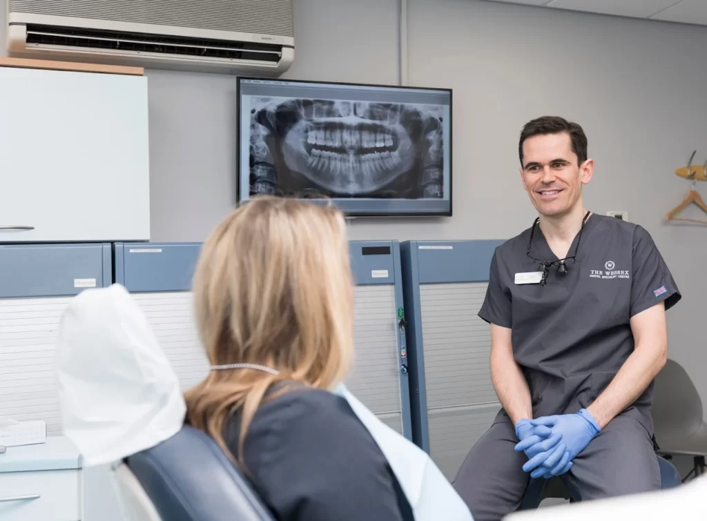 Specialist orthodontist assessing a patient’s teeth and bite during a consultation